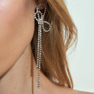 Bow and tassel earrings embellished with rhinestones
