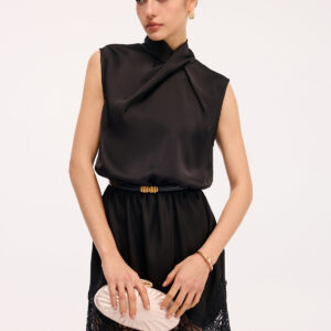 Sleeveless satin dress with lace trim and crisscross neckline.
